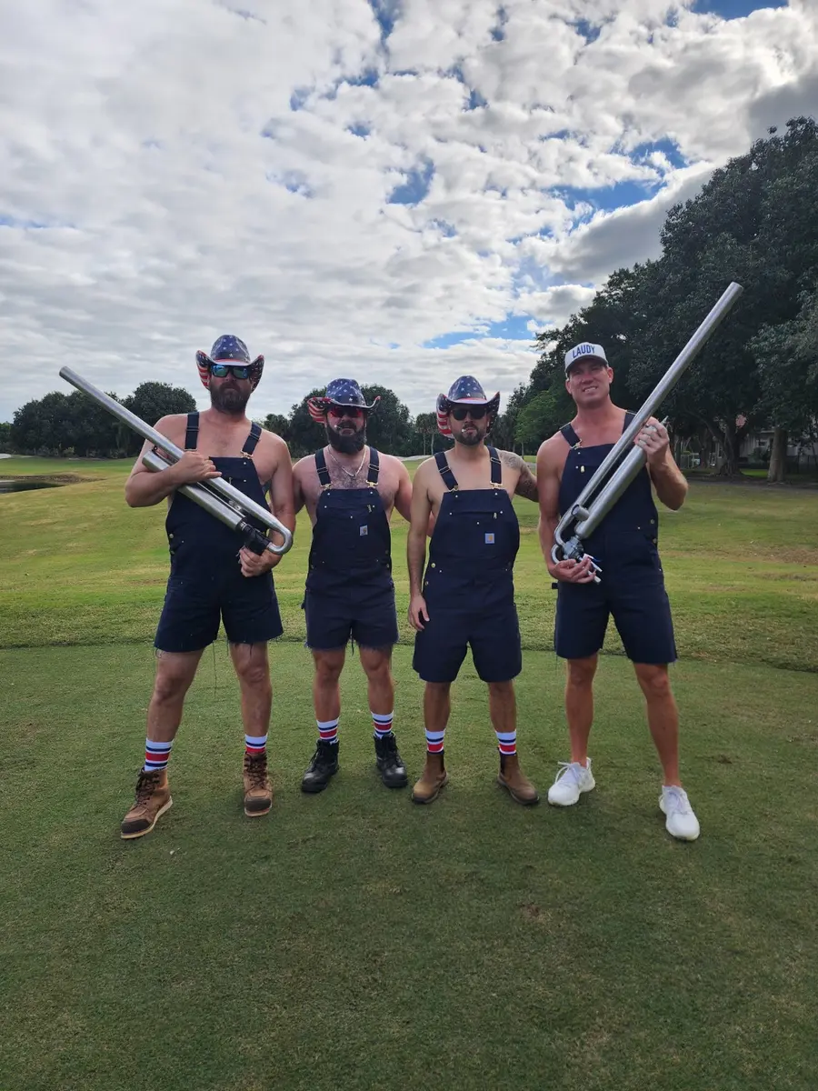 Golfers in patriotic outfits holding golf ball launchers